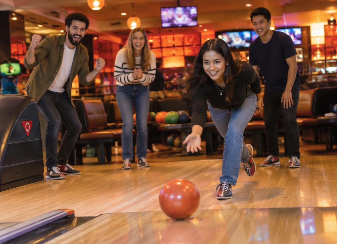 Friends cheering during a game of bowling